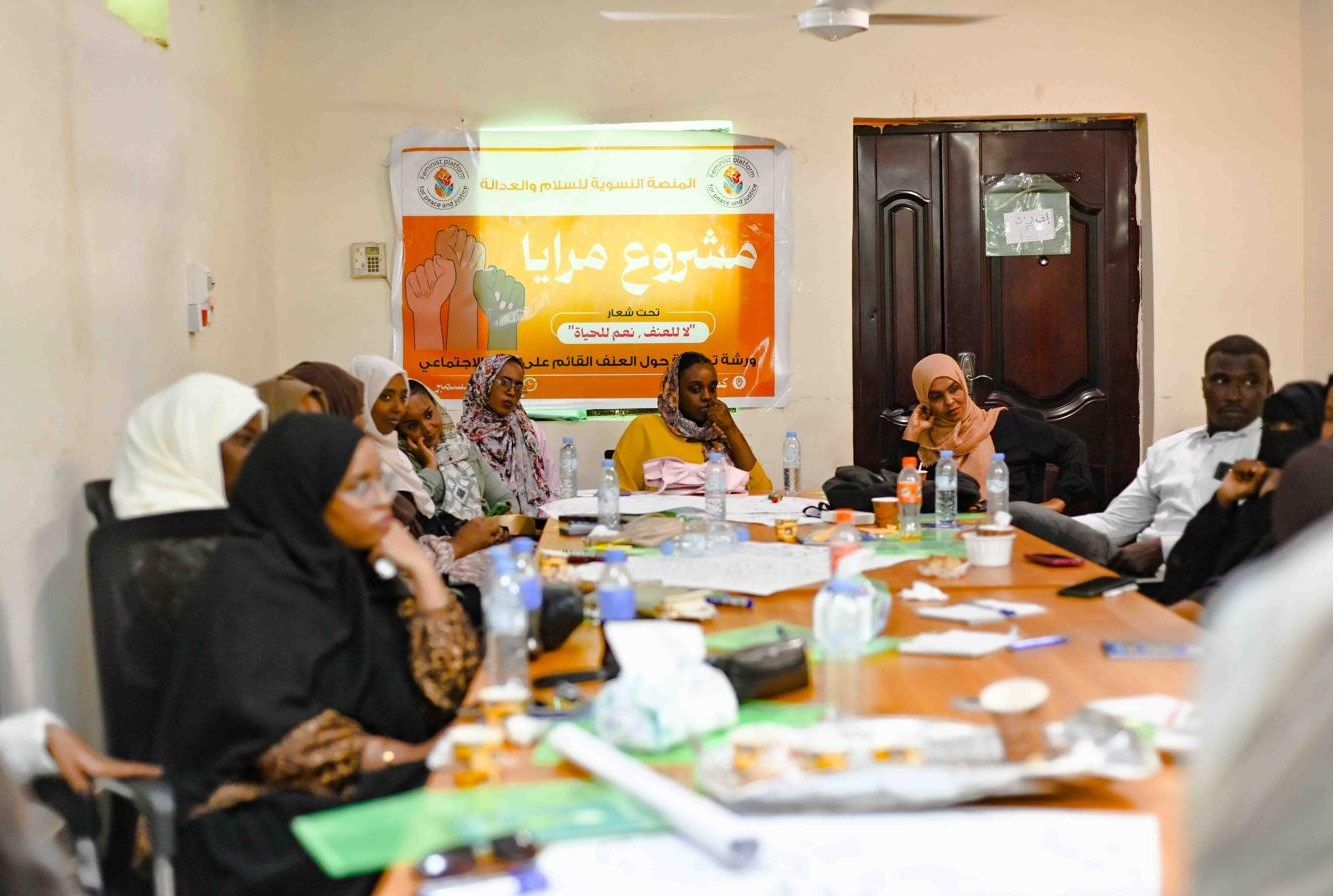 Participants seated around a long table during a workshop session
