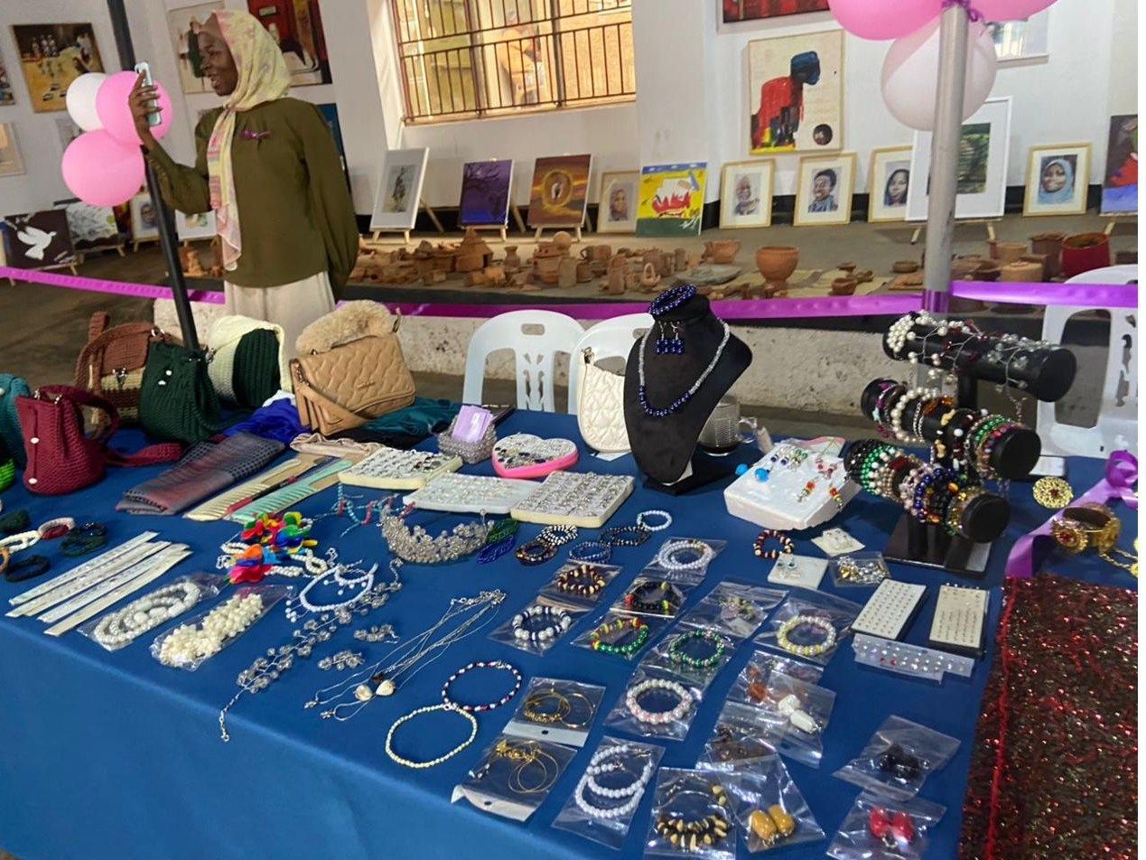 Handmade jewellery and craft work laid out on a table at an exhibition