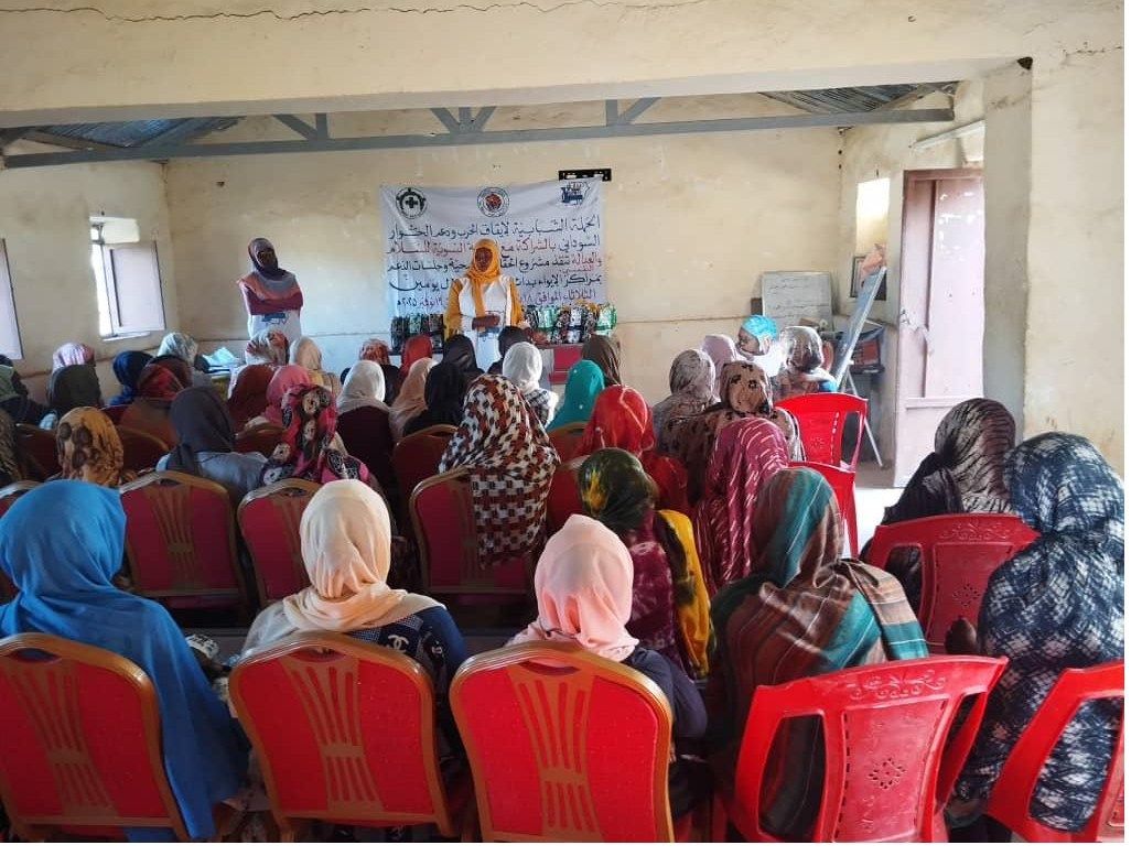 Women seated in rows facing a speaker at an indoor seminar